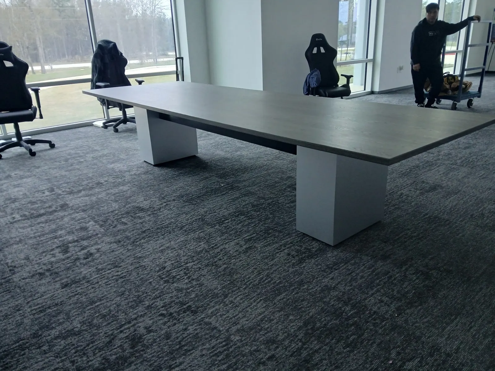 Crew moving furniture during a conference room installation