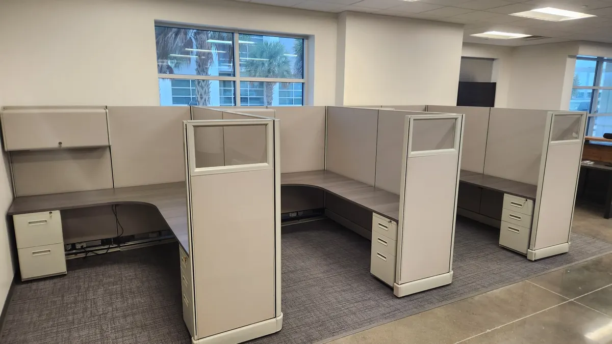 Open floor of installed office cubicles with overhead storage