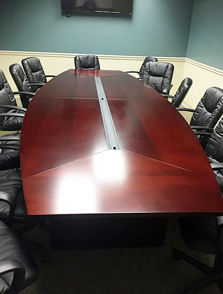 Mahogany boat-shaped boardroom table with leather seating