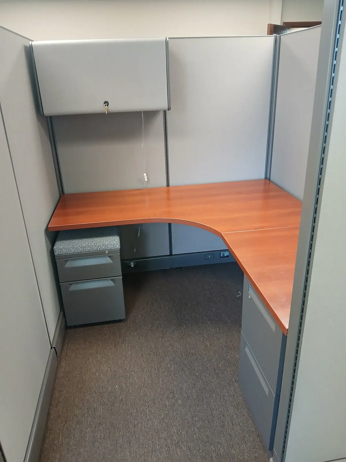 Cubicles with wood-tone work surfaces installed in Conroe