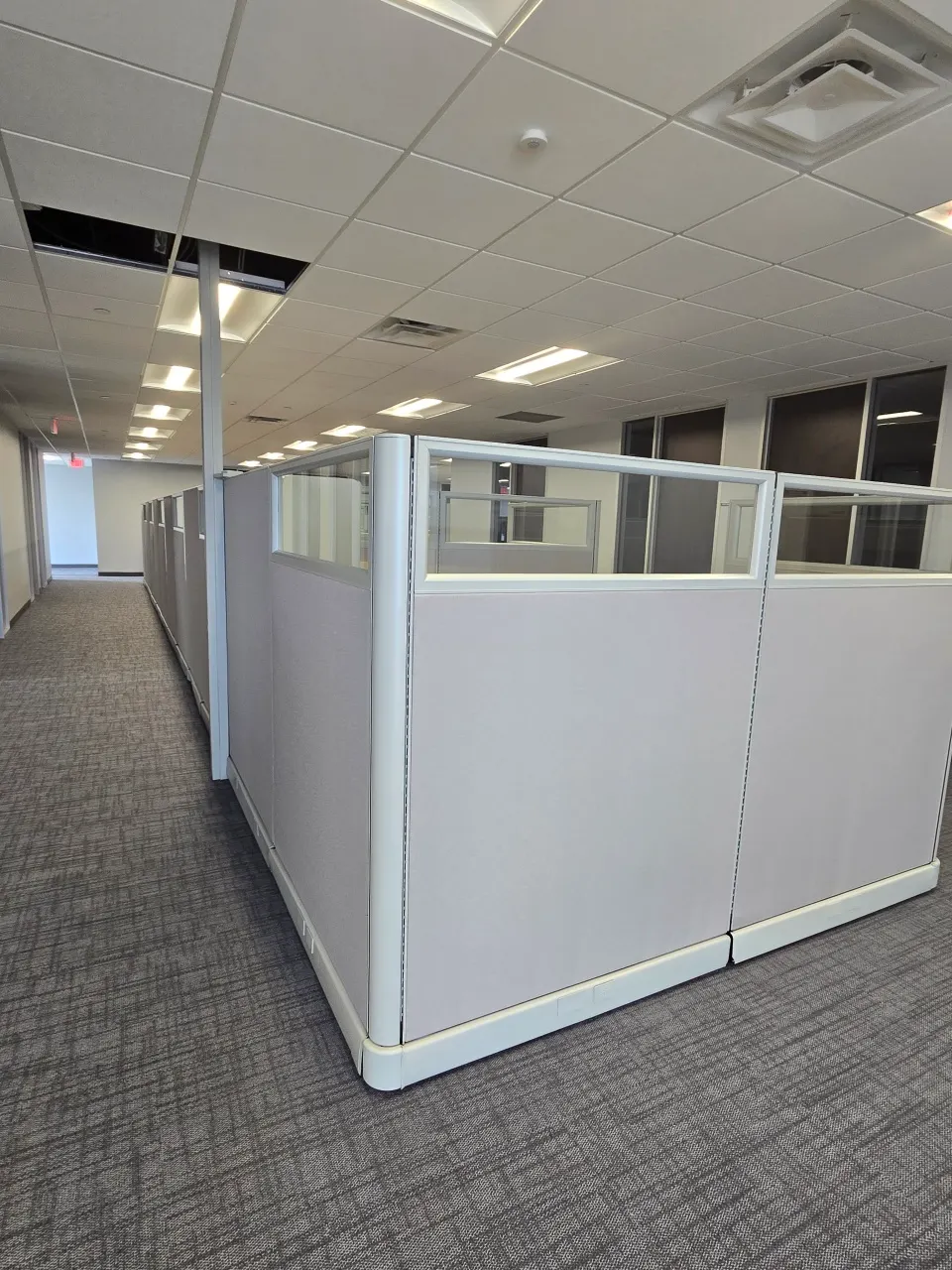Workstations with blue task chairs and mobile pedestals on an open floor