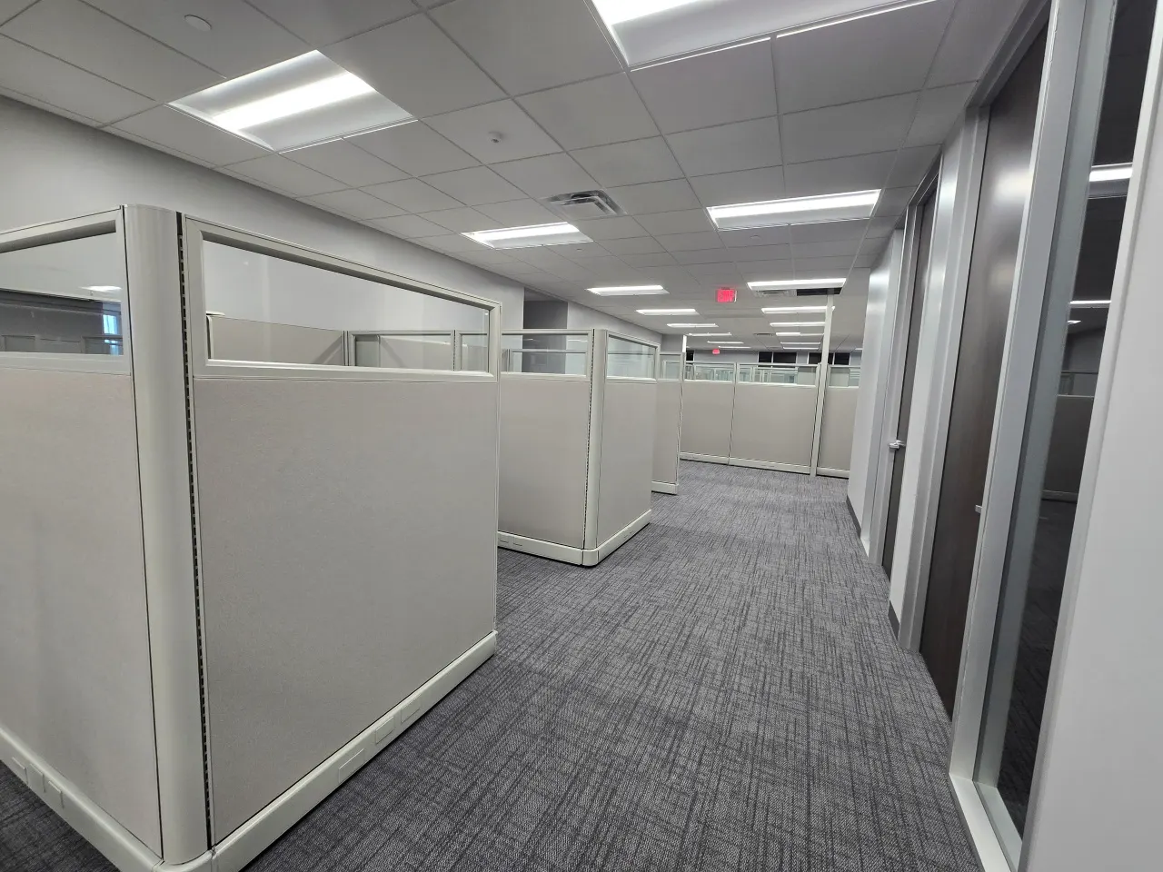 Planned workstation floor with glass-top panels laid out along a corridor