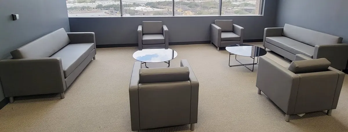 Office lobby with lounge chairs and round side tables